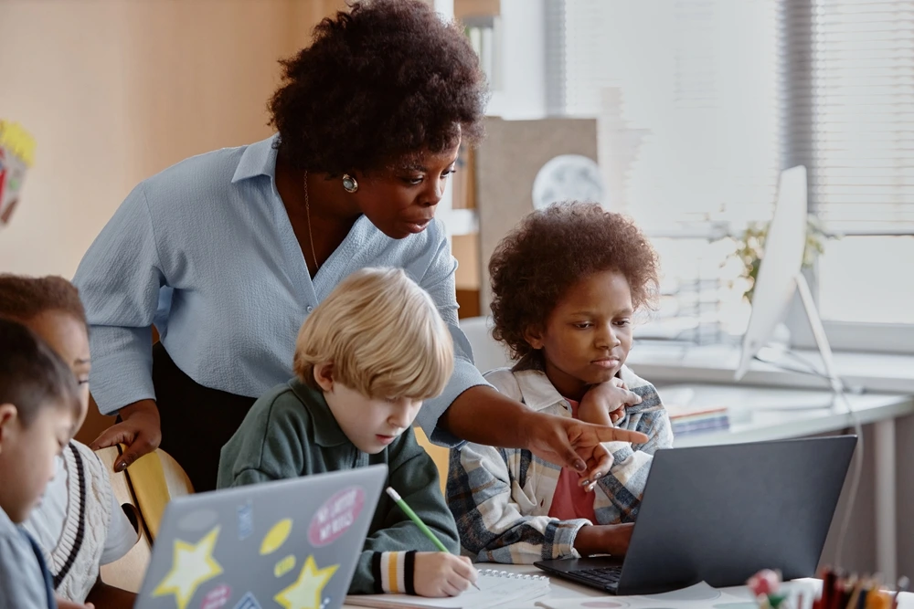 Teacher Students using laptop for studies